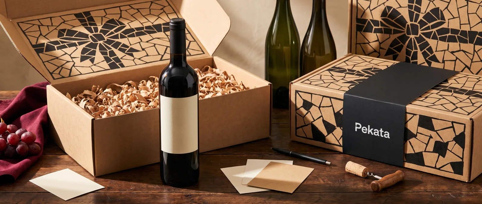Wine bottle with a blank label ready for customisation next to a Pekata box and label samples